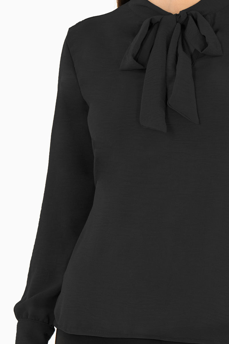 Blusa manga larga con moño en escote