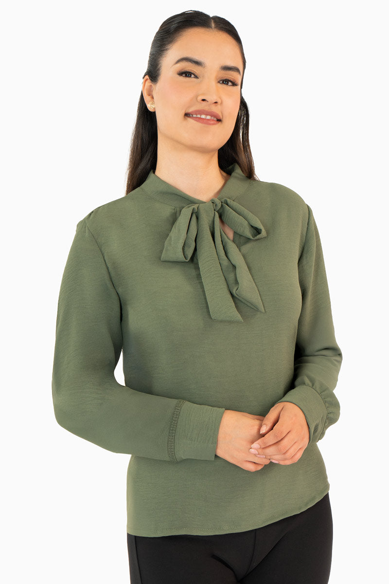 Blusa manga larga con moño en escote