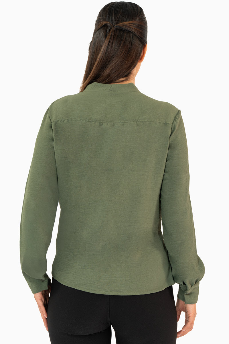 Blusa manga larga con moño en escote