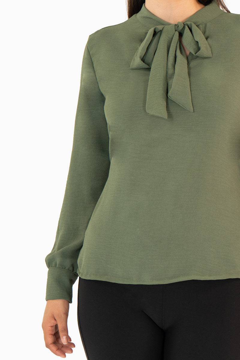 Blusa manga larga con moño en escote