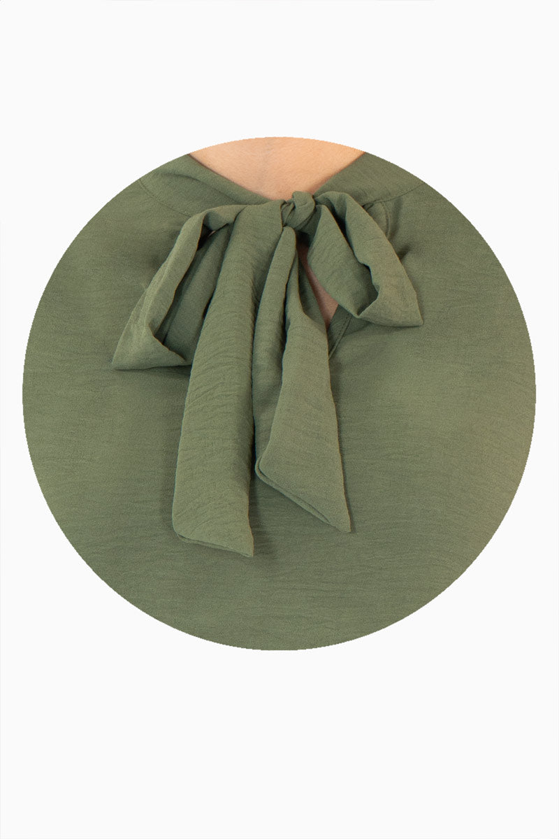 Blusa manga larga con moño en escote