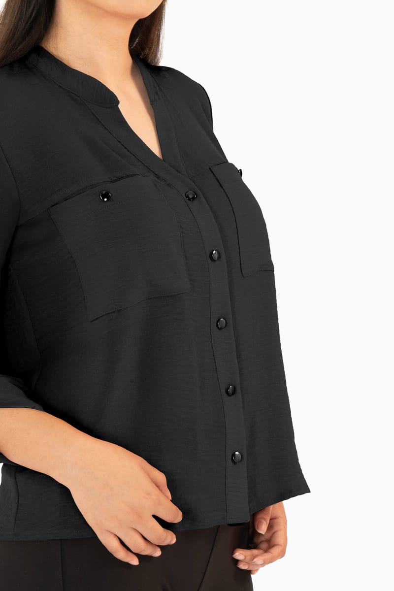 Blusa manga larga con bolsas y cuello mao
