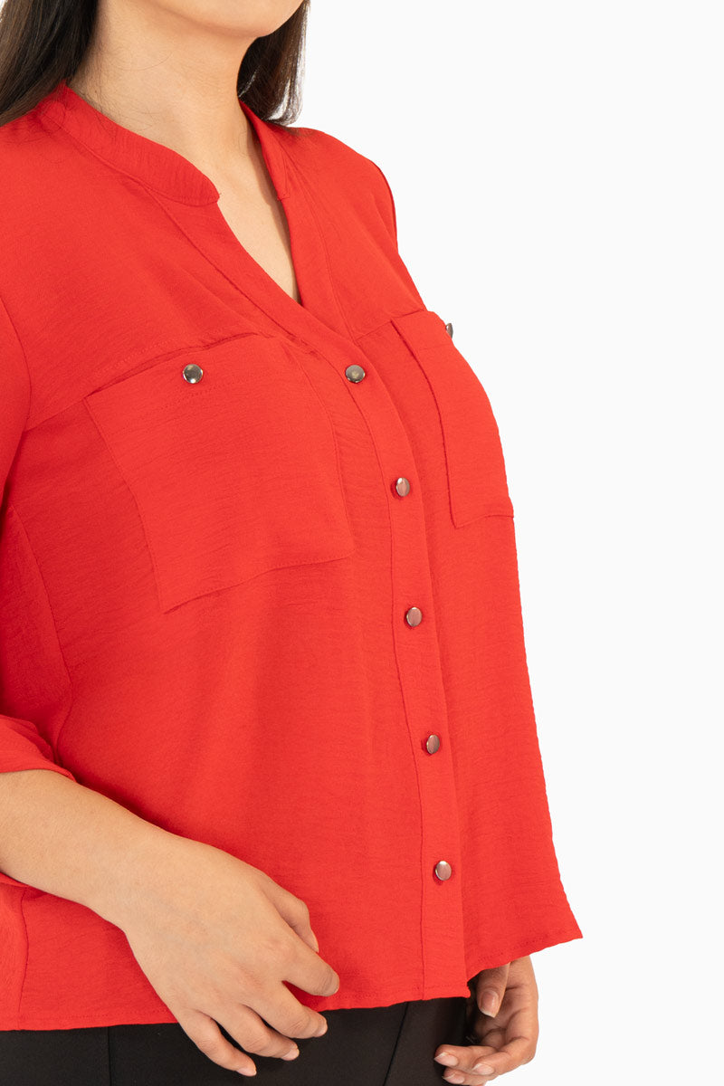 Blusa manga larga con bolsas y cuello mao