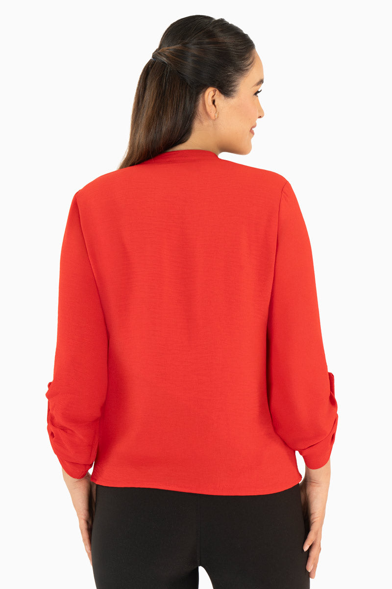 Blusa manga larga con bolsas y cuello mao